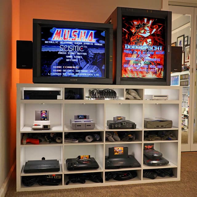 Retro gaming setup with CRT monitor, old consoles, and game cartridges